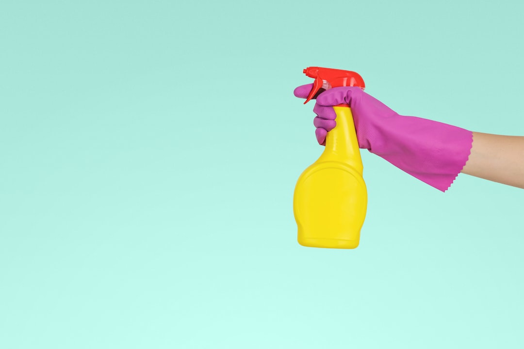 about-01 person-holding-yellow-plastic-spray-bottle-zmnefoi3k